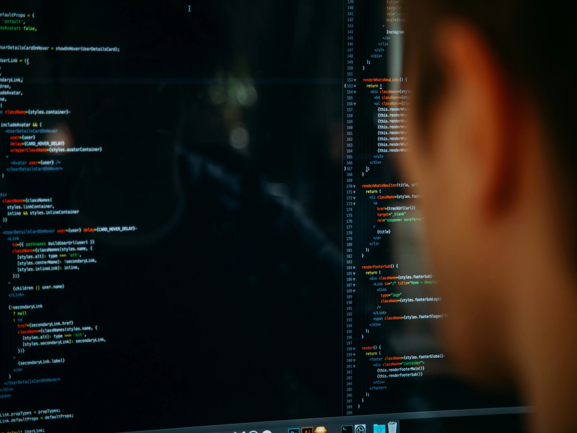 Close-up of a person concentrating on lines of code displayed on a computer monitor